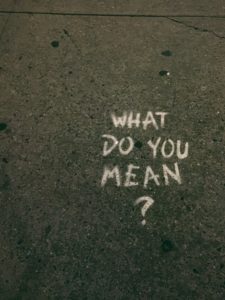 What do you mean? Written on a pavement in chalk.