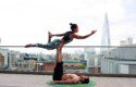 A man and a woman doing a yoga pose.