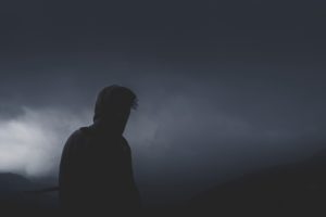 Silhouette of a man standing in thick fog.