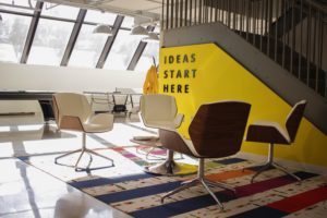 The words 'ideas start here' in black text on a yellow wall.